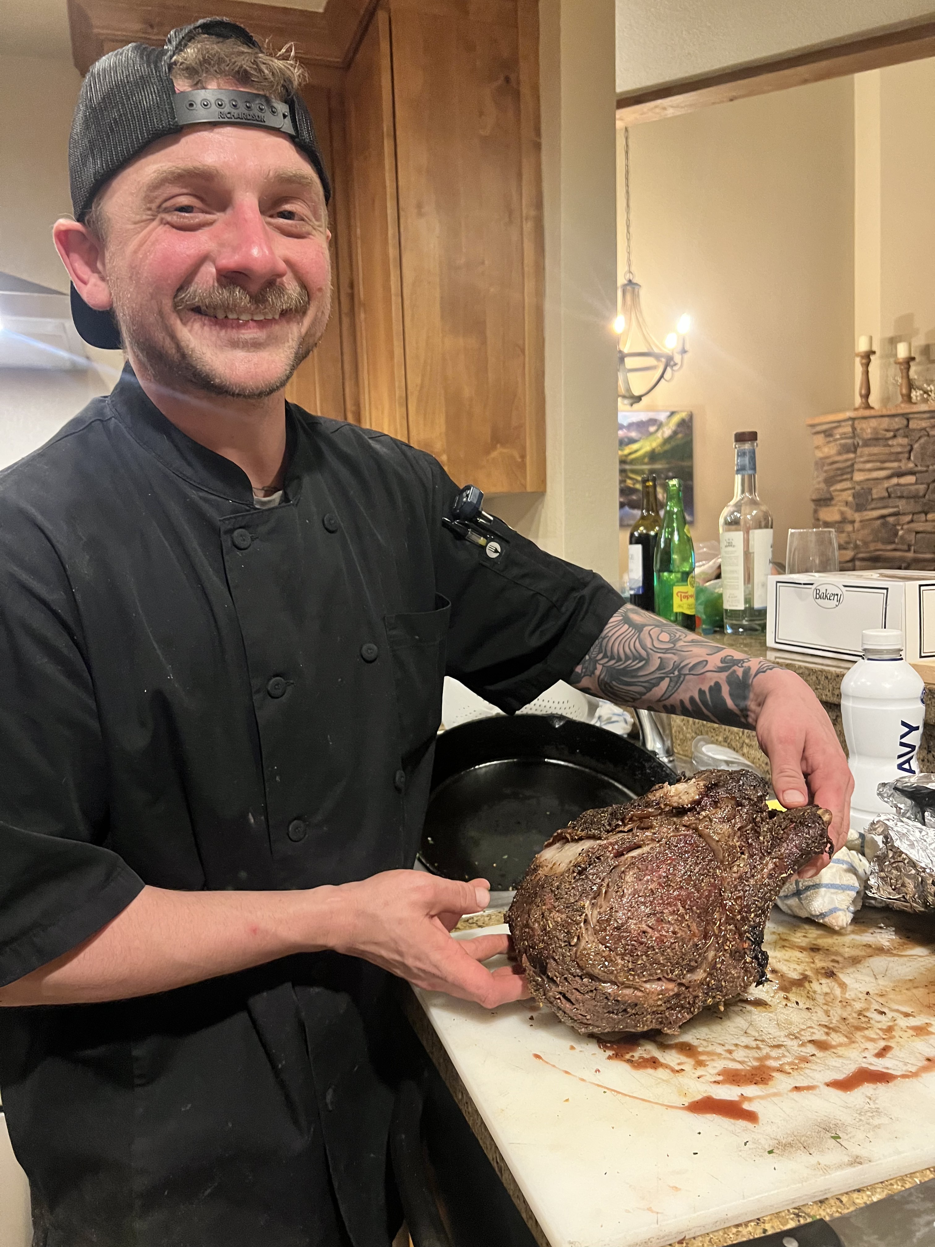 Stephen presenting a smoked prime rib roast in a Colorado cabin kitchen
